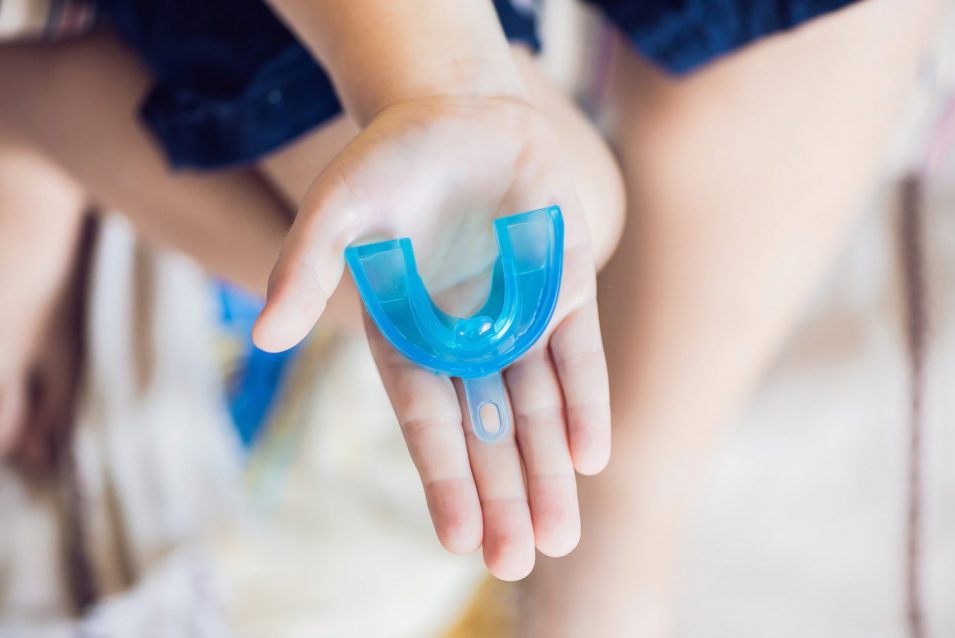 A dental Guard,provided by a dentist in Mindemoya, held in the palm of a hand