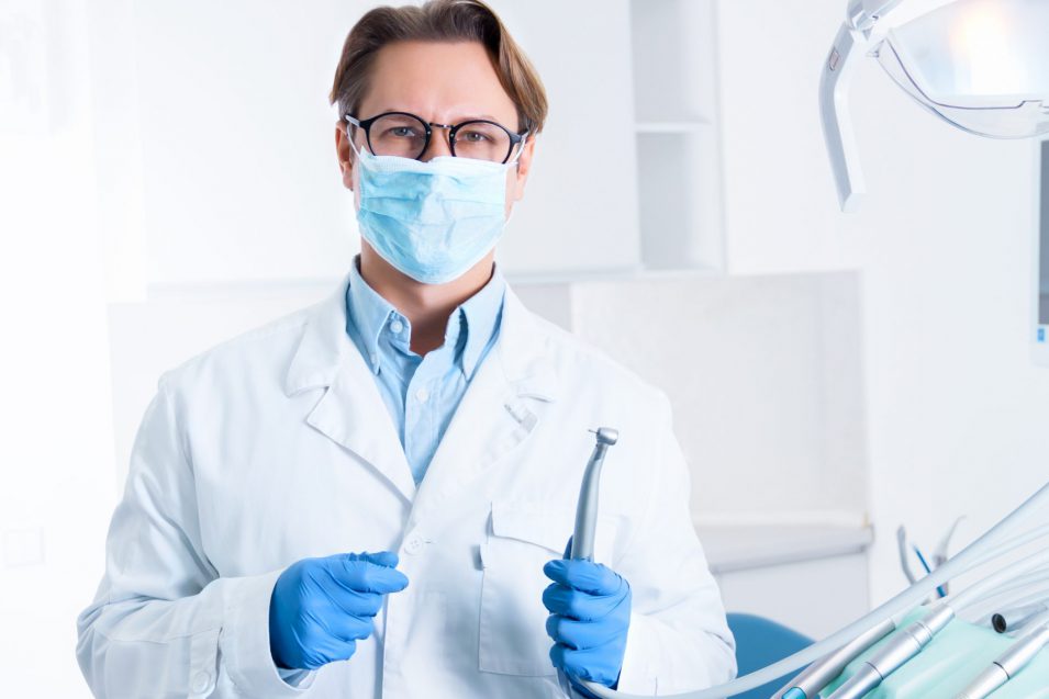 Cheerful male man dentist at dentist office