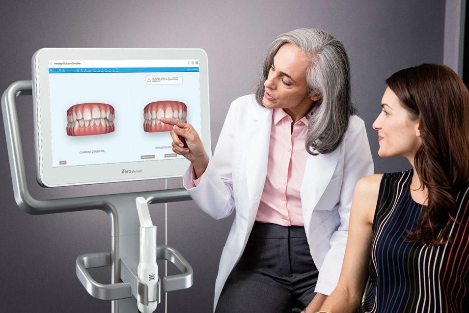 Dentist in Mindemoya discussing dental treatment with patient using the latest technology